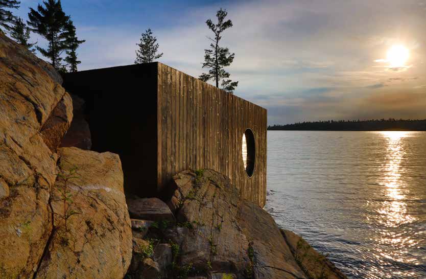 The charred cedar box wedged into the rock at sunset, the low sun laying a bright path across the water beside its oval opening.